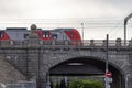 An electric train passes an old city bridge Royalty Free Stock Photo