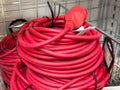 Red electrical extension cord coiled on metal shelf in hardware store Royalty Free Stock Photo