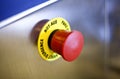 red emergency button on steel surface with round yellow alert sign Royalty Free Stock Photo