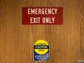 Red emergency exit and automatic door caution sign on clinic doo