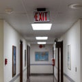 red emergency exit sign in the dark room. illuminated office exit sign Royalty Free Stock Photo