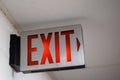 red emergency exit sign in the dark room. illuminated office exit sign Royalty Free Stock Photo