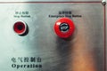 Red emergency stop button, inscriptions in English and Chinese Royalty Free Stock Photo