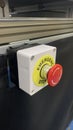 Red emergency stop button mounted on industrial equipment for safety and immediate machine shutdown Royalty Free Stock Photo