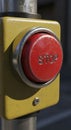 Red Emergency Stop Button on Yellow Control Panel Royalty Free Stock Photo