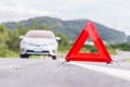 Red emergency stop sign and broken silver car Royalty Free Stock Photo