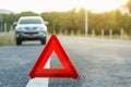 Red emergency stop sign and broken silver car on the road Royalty Free Stock Photo