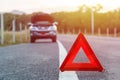 Red emergency stop sign and broken silver car on the road Royalty Free Stock Photo