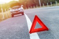 Red emergency stop sign and broken silver car on the road Royalty Free Stock Photo