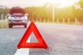 Red emergency stop sign and broken silver car on the road Royalty Free Stock Photo