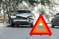 Red emergency stop triangle sign on road in car accident scene. Broken SUV car on road at traffic accident. Car crash traffic Royalty Free Stock Photo