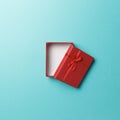 Red empty gift box with red ribbon on blue background. Top view. Flat lay. Copy space. Colorful background Royalty Free Stock Photo