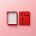 Red empty gift box with red ribbon on pink background. Top view. Flat lay. Copy space. Colorful background. Minimal christmas new