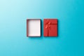 Red empty gift box with red ribbon on blue background. Top view. Flat lay. Copy space. Colorful background. Royalty Free Stock Photo