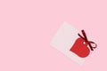 Red empty tag in a heart shape with tied ribbon bow and envelope. Royalty Free Stock Photo