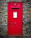 Red english letterbox on old wall at cheddar gorge england Royalty Free Stock Photo