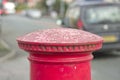 Red English pillar box or post box top on city space background. Royalty Free Stock Photo