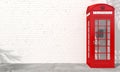 Red english telephone booth on brick wall background Royalty Free Stock Photo