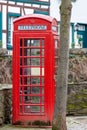 Red english telephone booth in front of a stone wall in Bad Muenstereifel Royalty Free Stock Photo