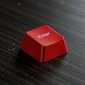 Red Enter keycap from a computer keyboard on a dark wooden surface. The keycap i Royalty Free Stock Photo