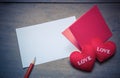 red envelop with shape heart pillow on text love, sheet of paper