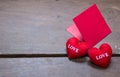 red envelop with shape heart pillow on text love