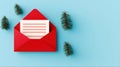 A Red Envelope with a Blank Lined Note Surrounded by Stylized Evergreen Sprigs on a Light Blue Background for Holiday or Royalty Free Stock Photo