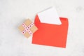 Red envelope with an empty paper, gift box with hearts, textured background, birthday, mothers day, fathers day and valintines day