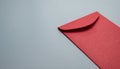 Red envelope on gray background with textured surface and shadow Royalty Free Stock Photo