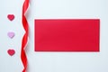 The red envelope with hearts and ribbon for Valentine`s Day. Royalty Free Stock Photo