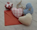 a red envelope made of paper. a gift box with a bow. hearts