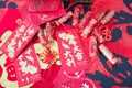 Red envelopes and firecracker ornaments scattered on red spring couplets background