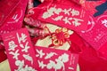 Red envelopes and firecracker ornaments scattered on red spring couplets background