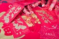 Red envelopes and firecracker ornaments scattered on red spring couplets background.The Chinese character on the red envelope mean
