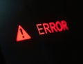 Red ERROR message and warning sign displayed on dark background, digital alert on computer screen. System malfunction or data Royalty Free Stock Photo