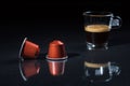 Espresso pods and coffee cup on black background, Closeup view with details Royalty Free Stock Photo