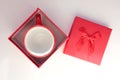 Red espresso coffee cup in gift box on white table. Top view, copy space. Valentines day concept Royalty Free Stock Photo