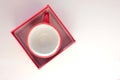 Red espresso coffee cup in gift box on white table. Top view, copy space. Valentines day concept Royalty Free Stock Photo