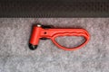 Red evacuation emergency break glass hammer tool on public trans