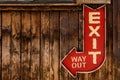 Red Exit Arrow on Wooden Wall