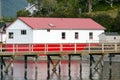 Red exterior of houses at marina near Tofino Pier