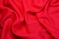 Red fabric background. Red cloth waves background texture. Royalty Free Stock Photo