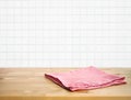 Red fabric,cloth on wood table top on blur white brick wall background of kitchen Royalty Free Stock Photo