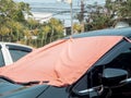 Red fabric covered on car front window for heat protection from sunshine