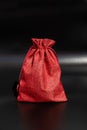 Red fabric drawstring bag on black background Royalty Free Stock Photo