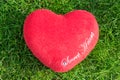 Red fabric heart love on green grass Royalty Free Stock Photo