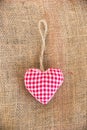 Red fabric heart, rustic canvas background Royalty Free Stock Photo