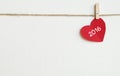 Red fabric heart with 2016 word hanging on the clothesline Royalty Free Stock Photo