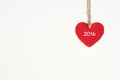 Red fabric heart with 2016 word hanging on the clothesline Royalty Free Stock Photo