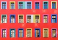 Red facade with colourful windows Royalty Free Stock Photo